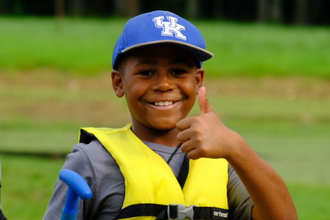 Boy with UK hat at 4-H summer camp